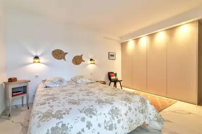 Un ou plusieurs lits dans un hébergement de l'établissement Appartement Reina Pointe Croisette Palm Beach