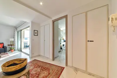 Un ou plusieurs lits dans un hébergement de l'établissement Appartement Reina Pointe Croisette Palm Beach