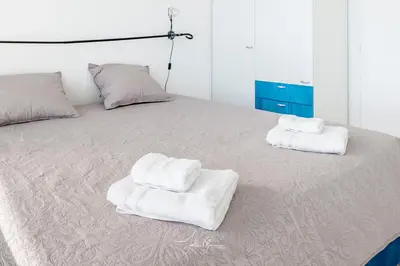 Un ou plusieurs lits dans un hébergement de l'établissement Acquamarina Duplex dernier étage