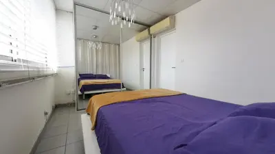 Un ou plusieurs lits dans un hébergement de l'établissement Palais Porte de France Apartment With Air conditionner