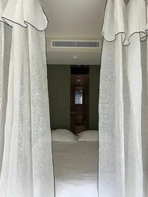 Un ou plusieurs lits dans un hébergement de l'établissement Palm Beach front de mer