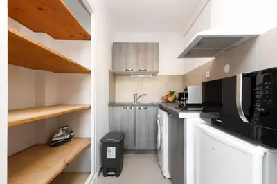 Cuisine ou kitchenette dans l'établissement Le Lido YourHostHelper