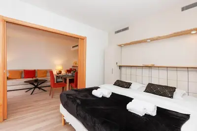 Un ou plusieurs lits dans un hébergement de l'établissement Pavillon Riviera YourHostHelper
