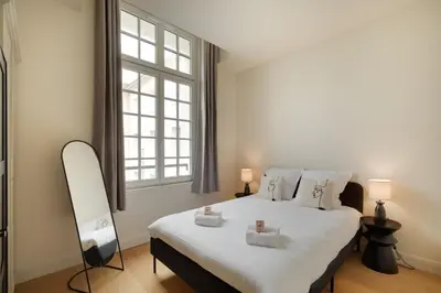 Un ou plusieurs lits dans un hébergement de l'établissement Appartement Place de Gaulle - Welkeys