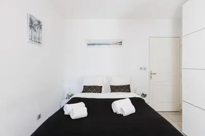 Un ou plusieurs lits dans un hébergement de l'établissement Cannes Maria YourHostHelper