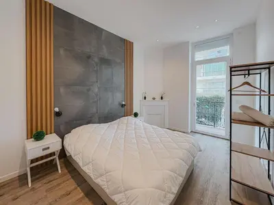 Un ou plusieurs lits dans un hébergement de l'établissement Cozy Home Cannes