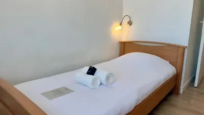 Un ou plusieurs lits dans un hébergement de l'établissement Scène & Palmiers - Cannes
