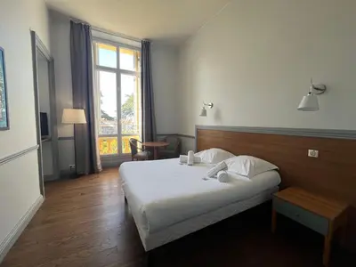 Un ou plusieurs lits dans un hébergement de l'établissement Hôtel Windsor
