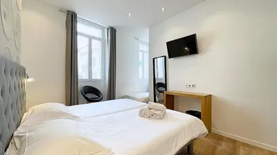 Un ou plusieurs lits dans un hébergement de l'établissement Hotel Le Florian