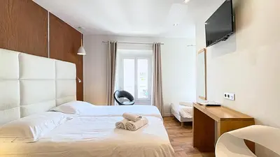 Un ou plusieurs lits dans un hébergement de l'établissement Hotel Le Florian