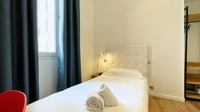 Un ou plusieurs lits dans un hébergement de l'établissement Hotel Le Florian