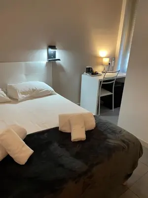 Un ou plusieurs lits dans un hébergement de l'établissement Hôtel Anna Livia