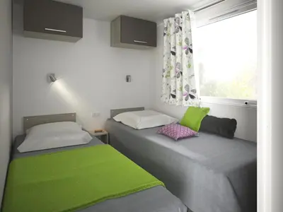 Un ou plusieurs lits dans un hébergement de l'établissement Bungalow Vacances