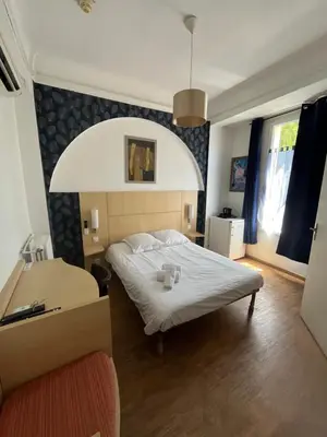 Un ou plusieurs lits dans un hébergement de l'établissement Hôtel Trianon