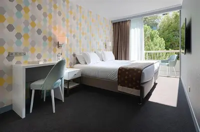 Un ou plusieurs lits dans un hébergement de l'établissement Juliana Hotel Cannes