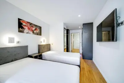 Un ou plusieurs lits dans un hébergement de l'établissement Appartements Croisette Grand Hôtel