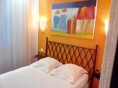 Un ou plusieurs lits dans un hébergement de l'établissement Hôtel Brimer Cannes