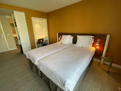 Un ou plusieurs lits dans un hébergement de l'établissement Hotel Abrial by Soniho