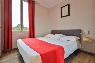 Un ou plusieurs lits dans un hébergement de l'établissement Emeraude Résidence Hotelière