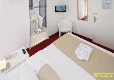 Un ou plusieurs lits dans un hébergement de l'établissement HOTEL PALM BEACH