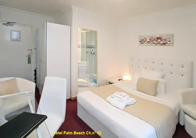 Un ou plusieurs lits dans un hébergement de l'établissement HOTEL PALM BEACH
