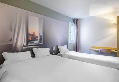 Un ou plusieurs lits dans un hébergement de l'établissement B&B HOTEL Antibes Sophia Le Relais